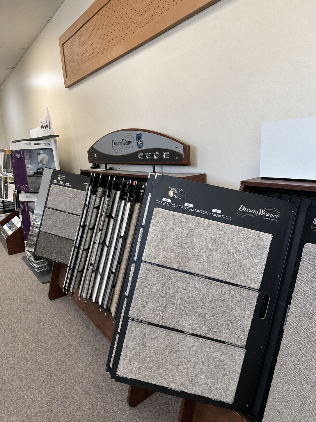 Close-up view of vinyl and luxury vinyl flooring samples in the showroom