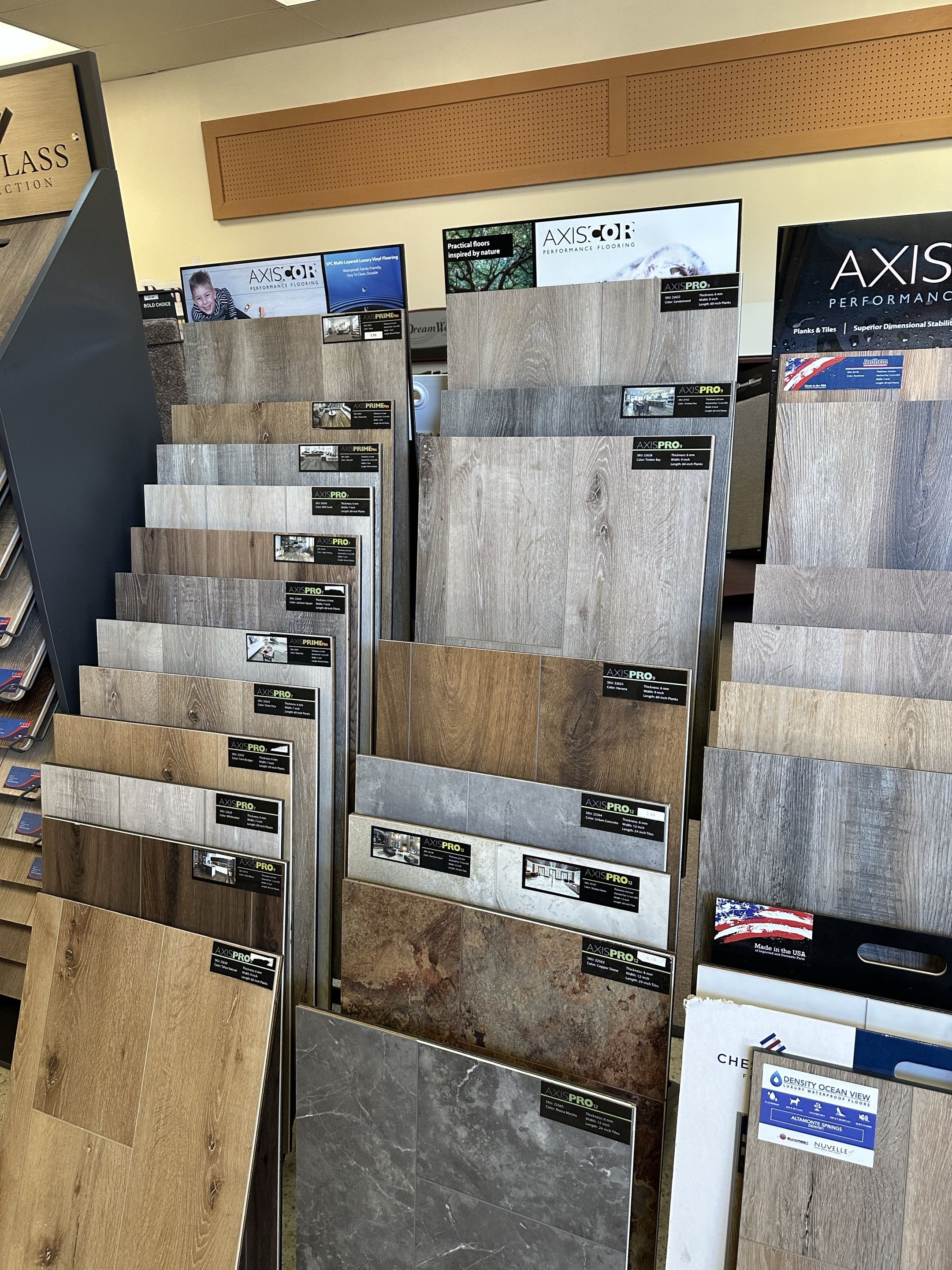 Carolina Floor Covering showroom displaying a wide selection of flooring samples including carpet, laminate, vinyl, and luxury vinyl options in Laurens, SC